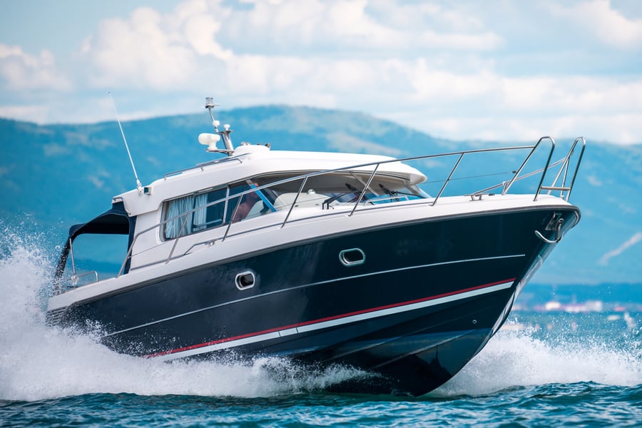 A Black Hull Speedboat Racing By Sea