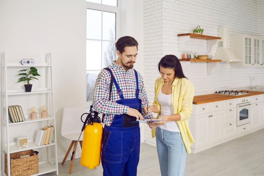 A Pest Exterminator Giving An Invoice