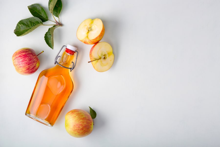 Apple Cider In A Glass Bottle And Fresh Apples.