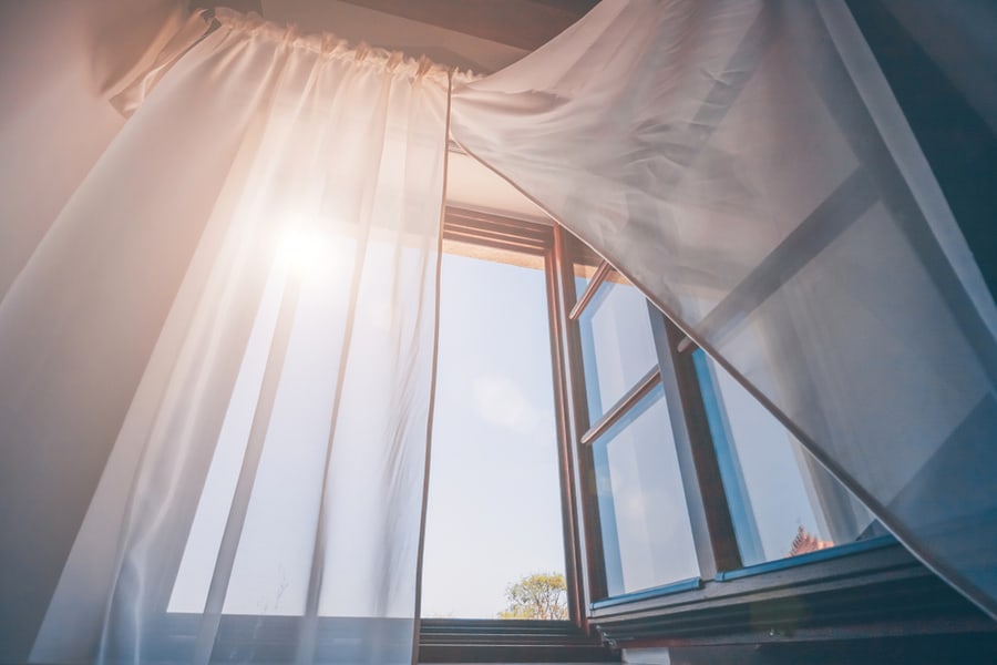 Bright Morning Sun In The Open Window Through The Curtains