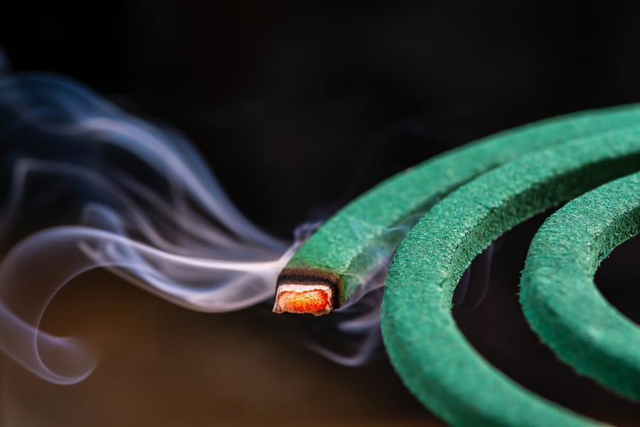 Burning Green Spiral Mosquito Repellent Coil And Red Fire With White Smoke