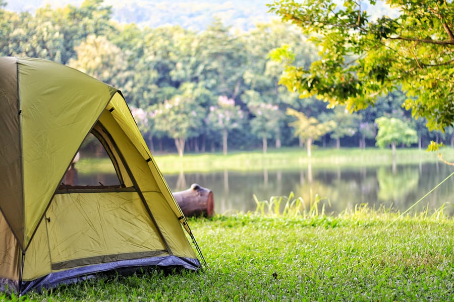 Camping Green Tent In Forest Near Lake