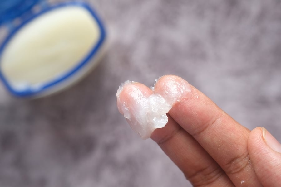 Close Up Of Man Hand Using Petroleum Jelly