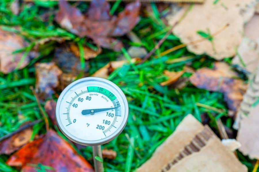 Compost Thermometer Inserted Into A Pile Of Composting