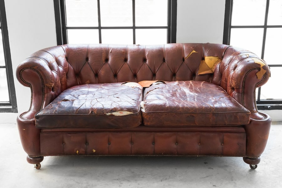 Defective Old Leather Sofa On White Room