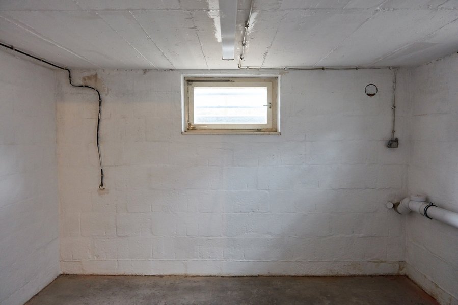 Empty Room In The Basement With A Window As A Boiler Room Or Drying Room