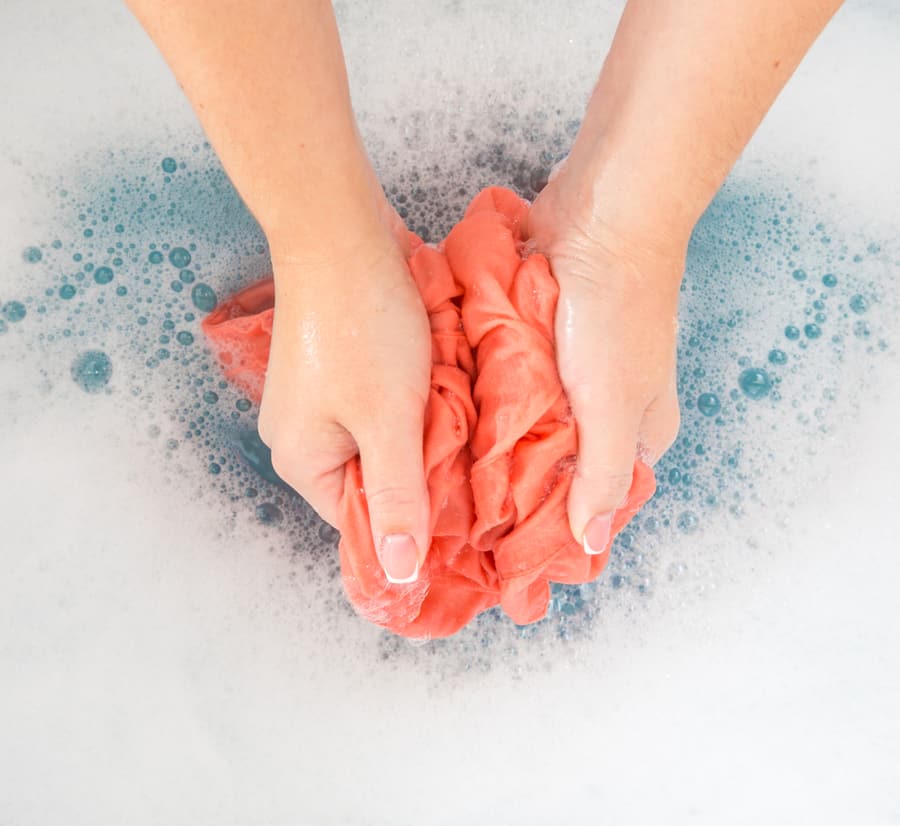 Female Hands Washing Color Clothes In Sink