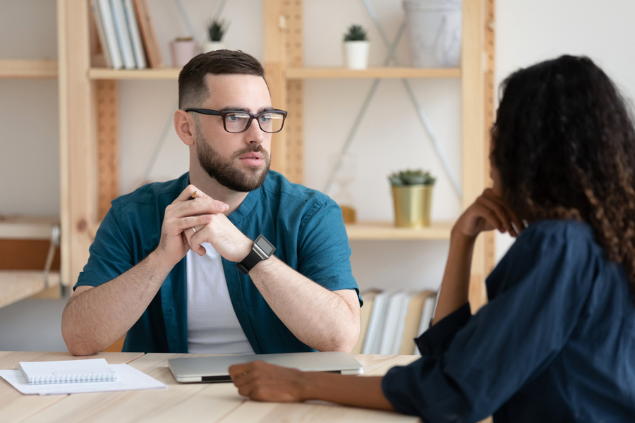 Focused Young Male In Glasses Holding Interview With African American Female