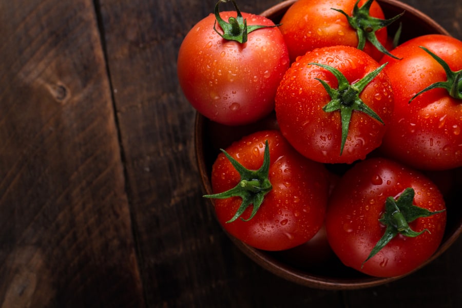 Fresh Tomatoes In A Plate On A Dark Background