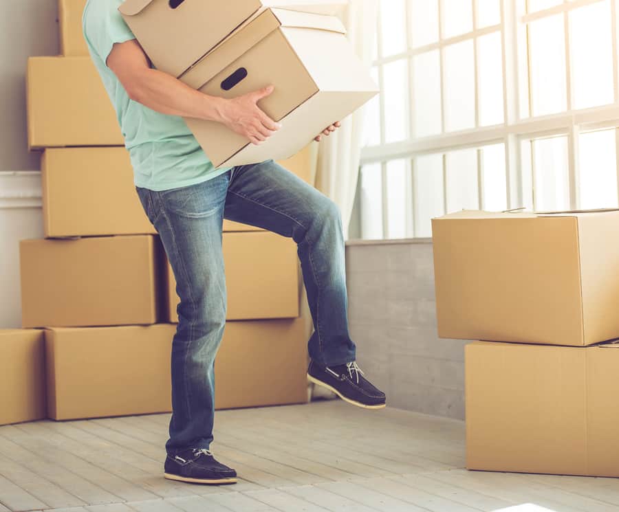 Man Carrying Boxes While Moving To The New Apartment