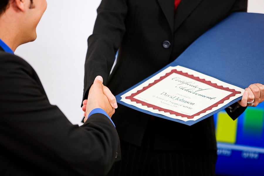 Man Receiving A Certificate Of Achievement