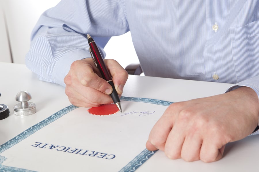 Man Signing A Certificate