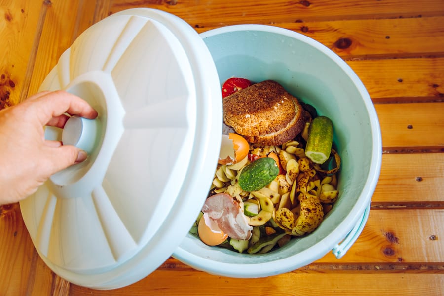 Organic Food Waste In Garbage Bin Bucket With Lid In Home On Floor To Be Composted