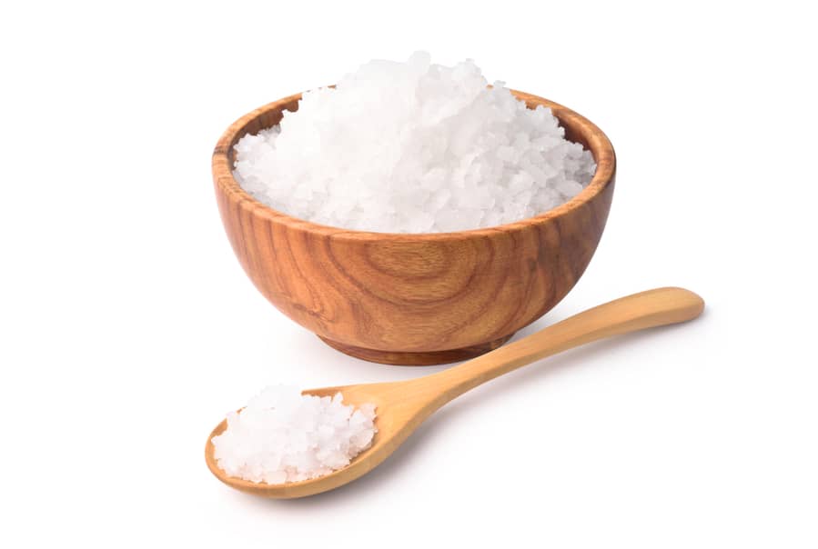 Pure Natural Sea Salt In Wooden Bowl And Wooden Spoon Isolated On White Background.