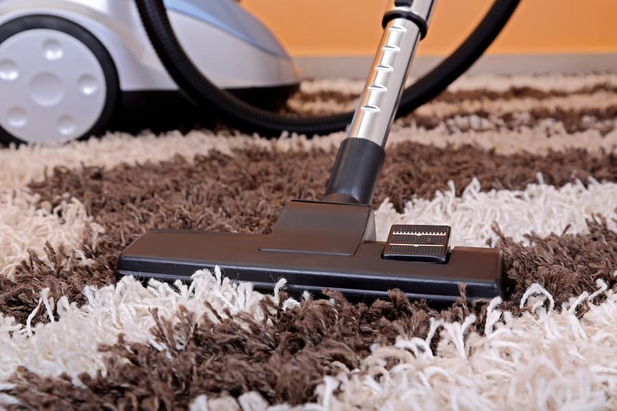 Vacuum Cleaner On Fluffy Carpet