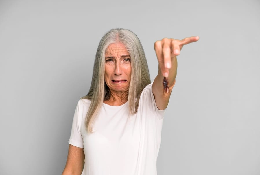 Woman Holding Cockroach With Her Fingers