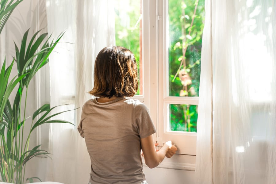 Woman Looking Outside Window