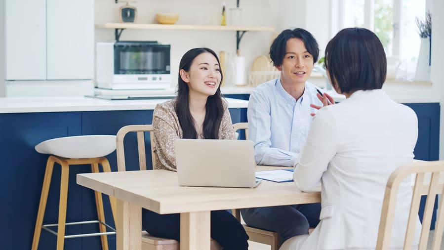 Young Asian Couple And Woman Meeting In The Modern House
