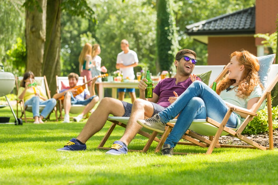 Young Friends Having Fun At Backyard Barbecue Party