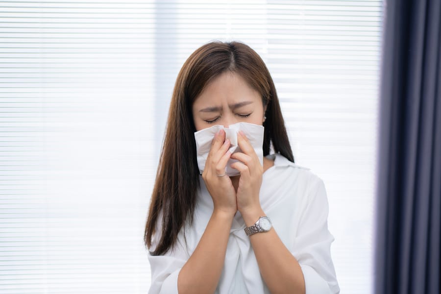 A Woman Sneezing