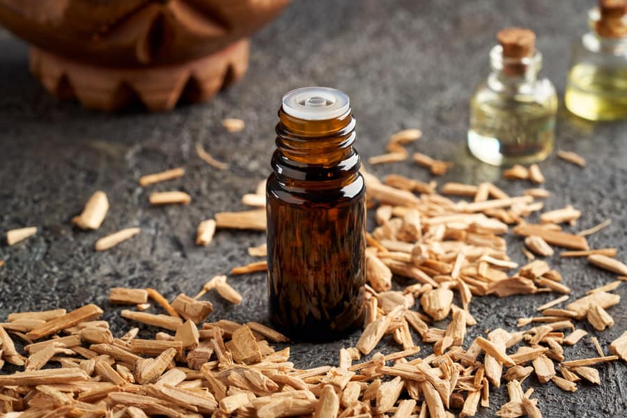 Dark Bottle Of Essential Oil With Cedar Wood