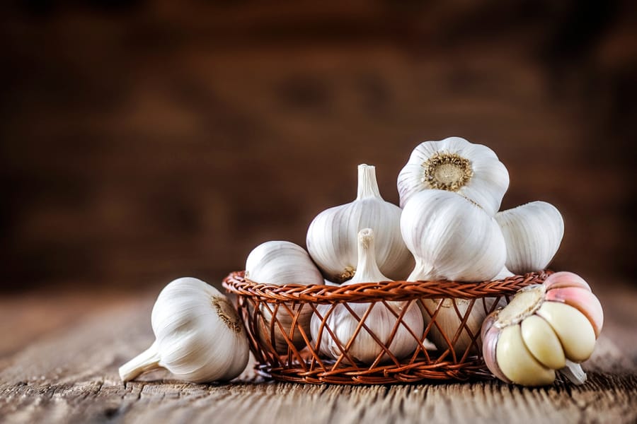 Fresh Garlics In Wooden Basket