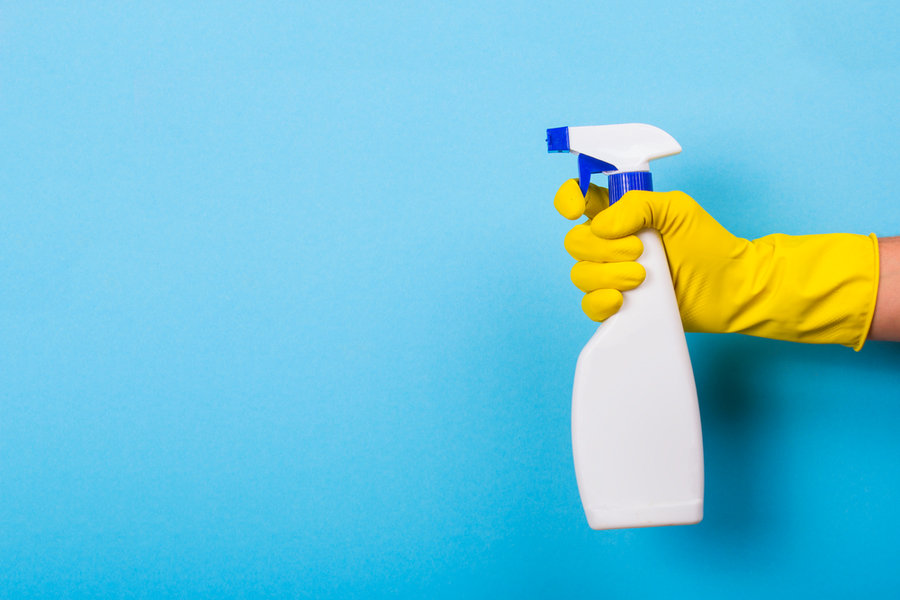 Hand In A Yellow Glove Holds A Spray Bottle