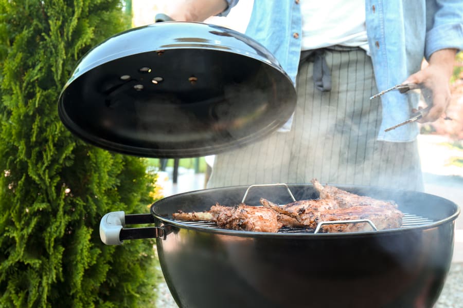 Man Cooking Ribs On Barbecue Grill