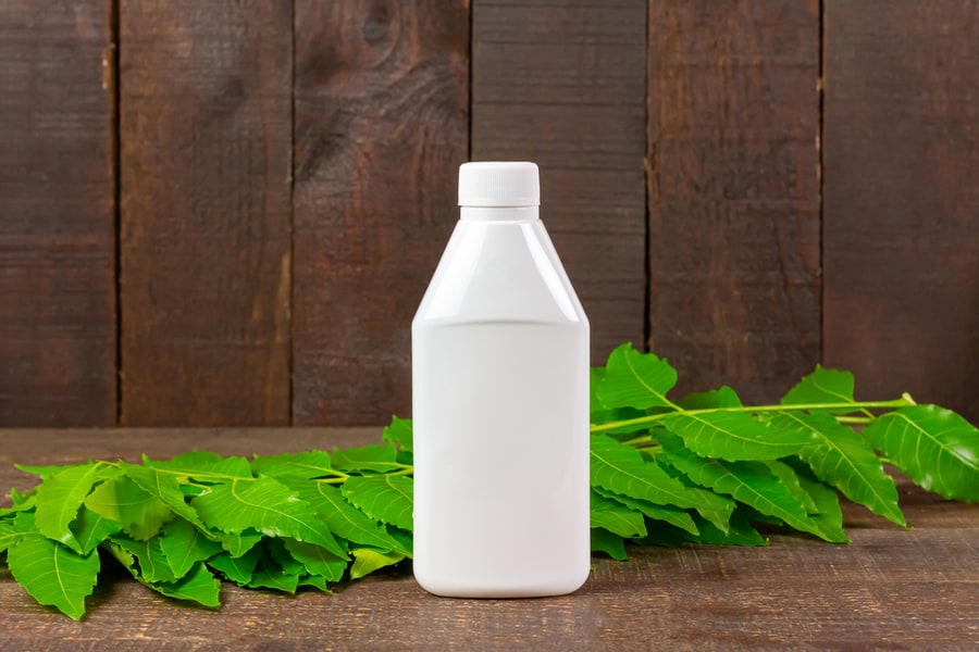 Neem Oil In White Plastic Bottle