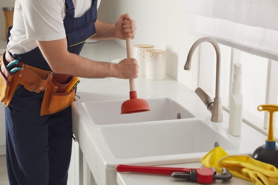 Plumber Using Plunger