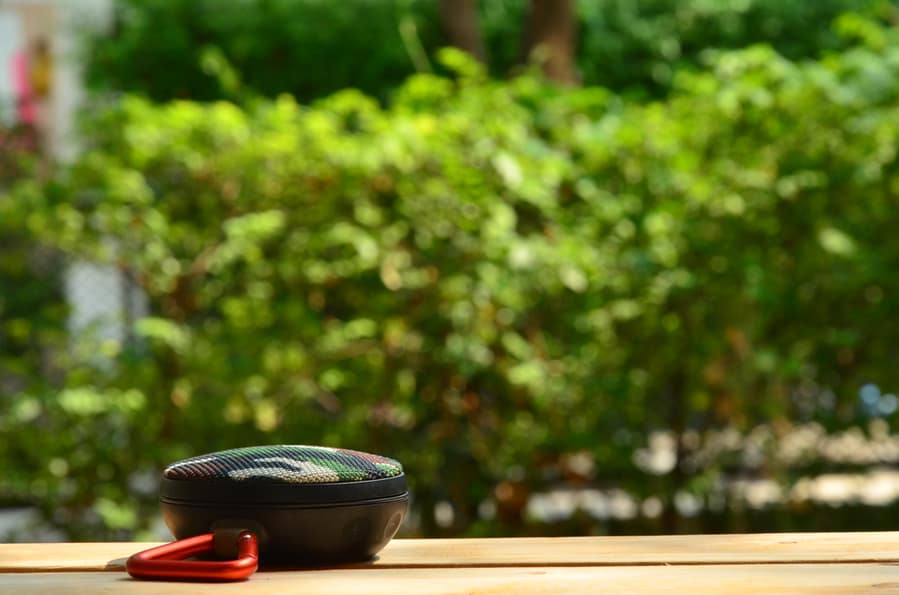 Portable Speaker On Wooden Vintage Table.