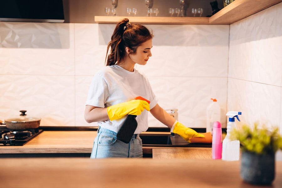 Young Girl Cleaning The Kitchen