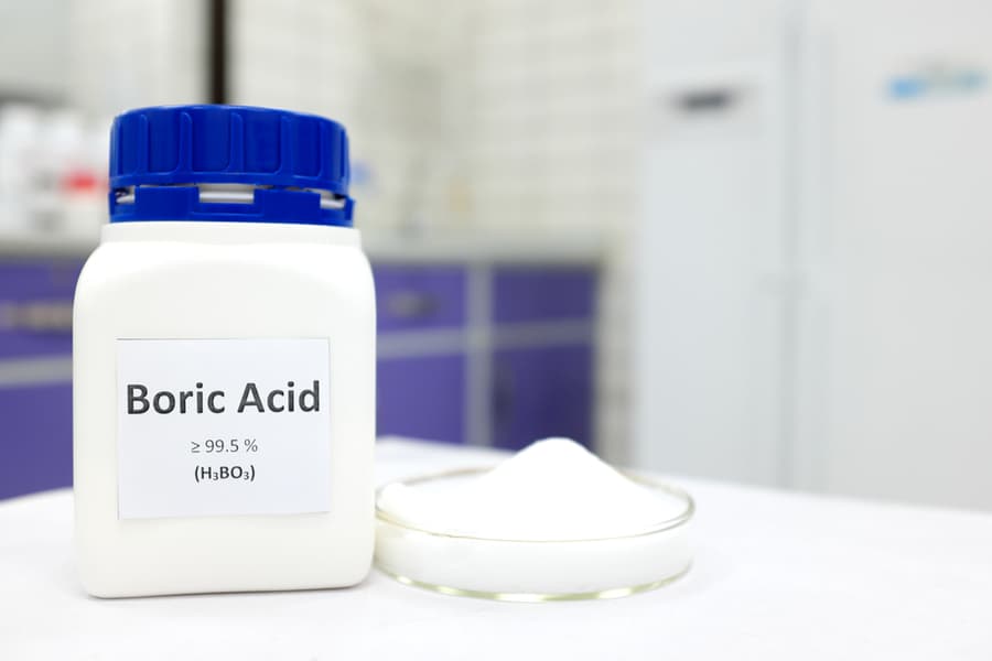 Bottle Of Pure Boric Acid Chemical Compound Beside A Petri Dish