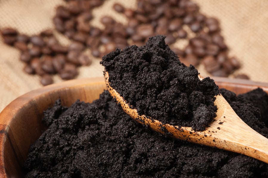 Closeup Detail Of Used Coffee Grounds In Wooden Bowl