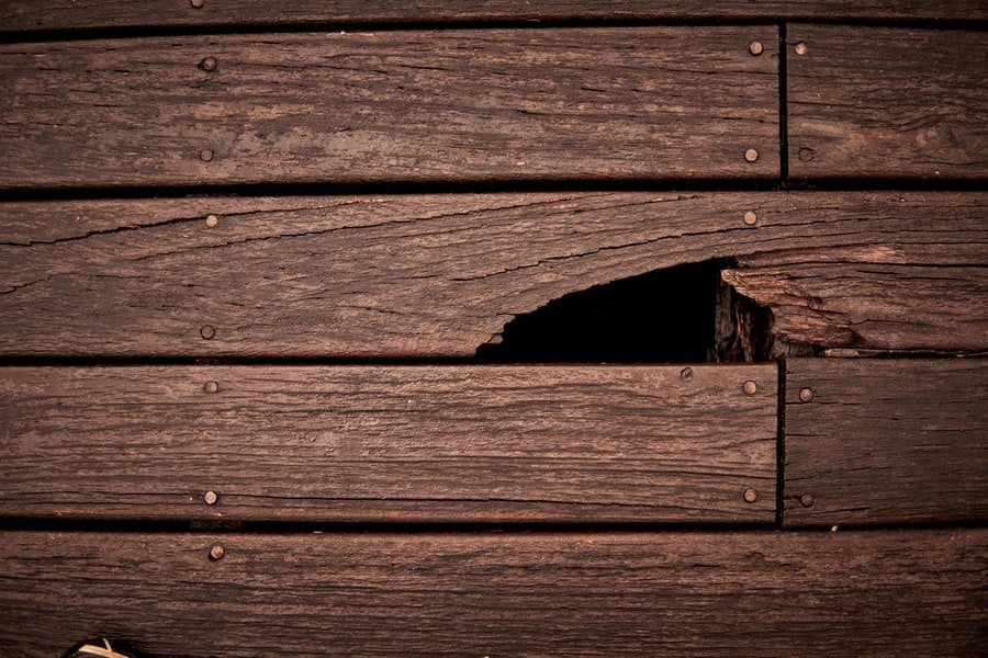 Hole In Brown Wooden Wall