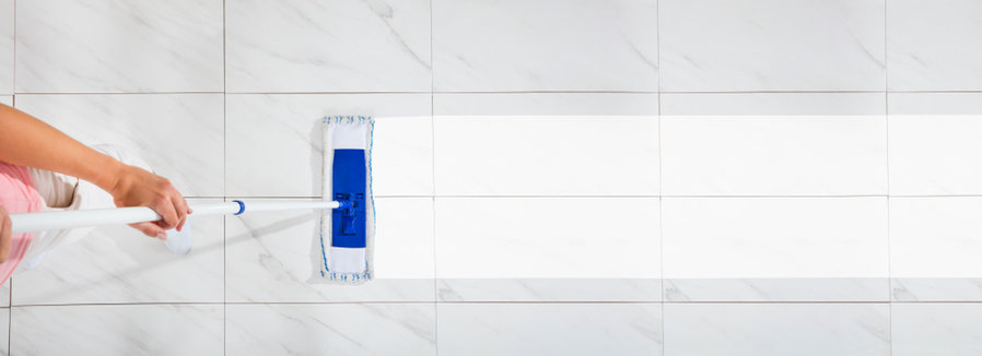 An Overhead View Of A Female Cleaning The White Floor With Wet Mop